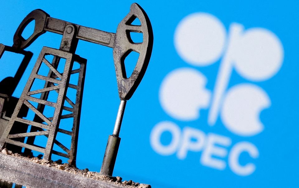 Close-up of an oil pump jack silhouette against a blue background featuring the OPEC logo, symbolizing the organization’s influence on global oil production and pricing.